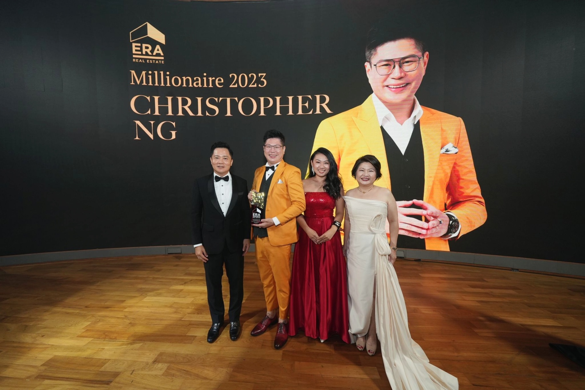 Christopher receiving Millionaire 2023 recognition on stage