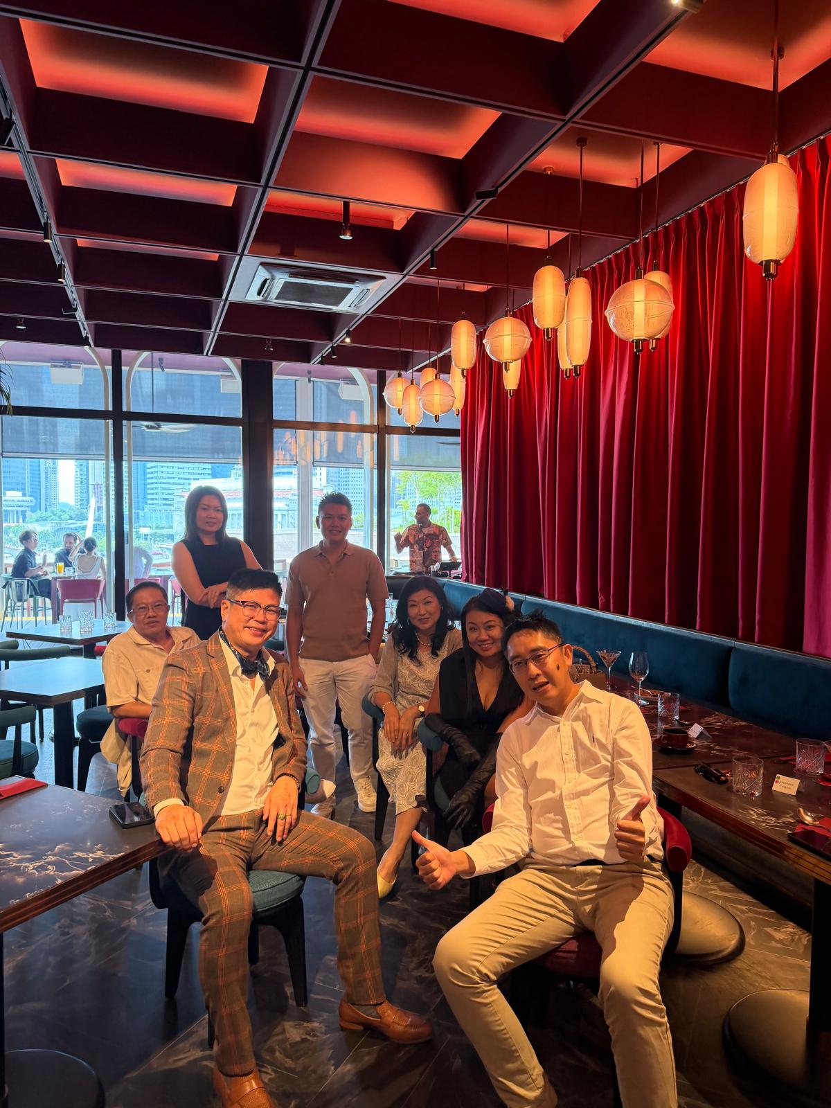 Christopher with friends and clients at a Marina Bay dinner