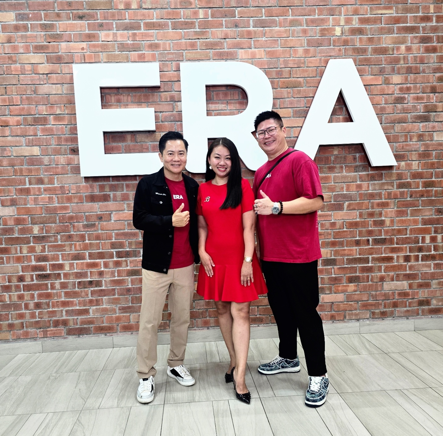 Christopher with team at the ERA HQ wall